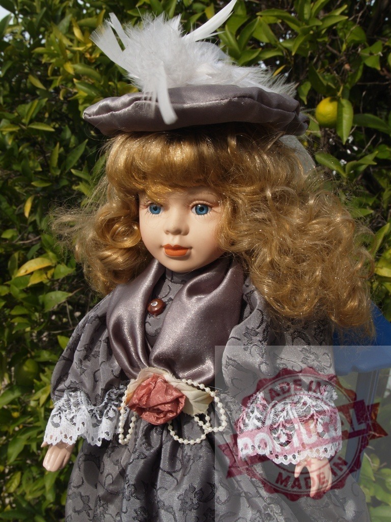 Porcelain doll with feathered hat standing outdoors | Porcelain doll wearing a vintage Victorian dress with lace trim and pearls - Realized with Pictrs.com