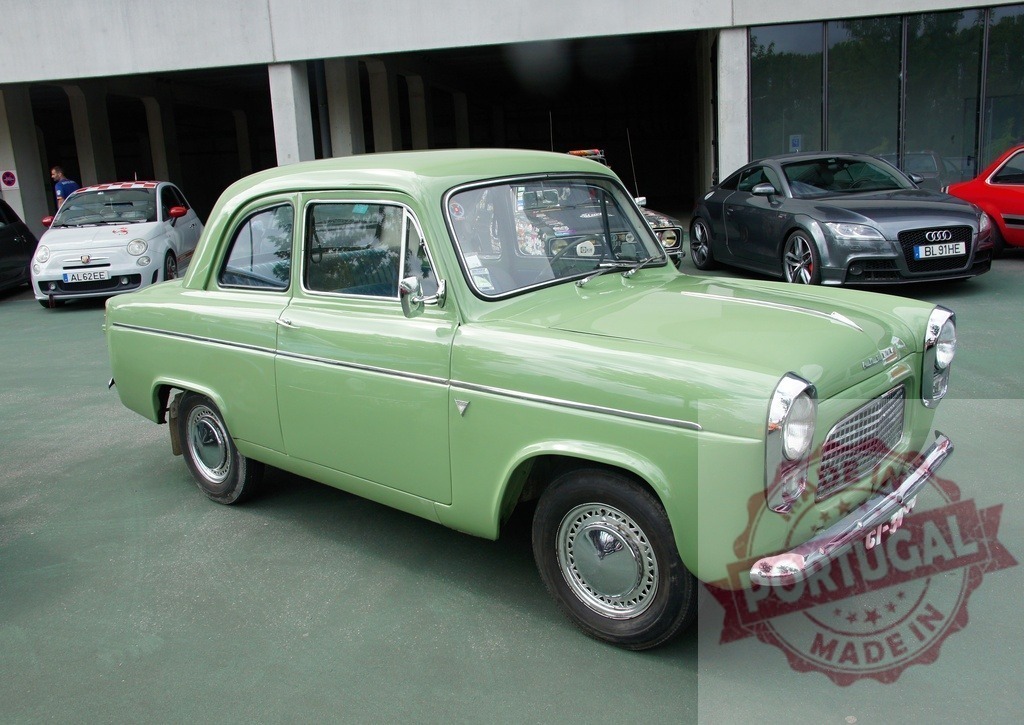 Ford Prefect 100E classic light green sedan at car show | Ford Prefect 100E vintage car parked on asphalt, showcasing retro design - Realized with Pictrs.com