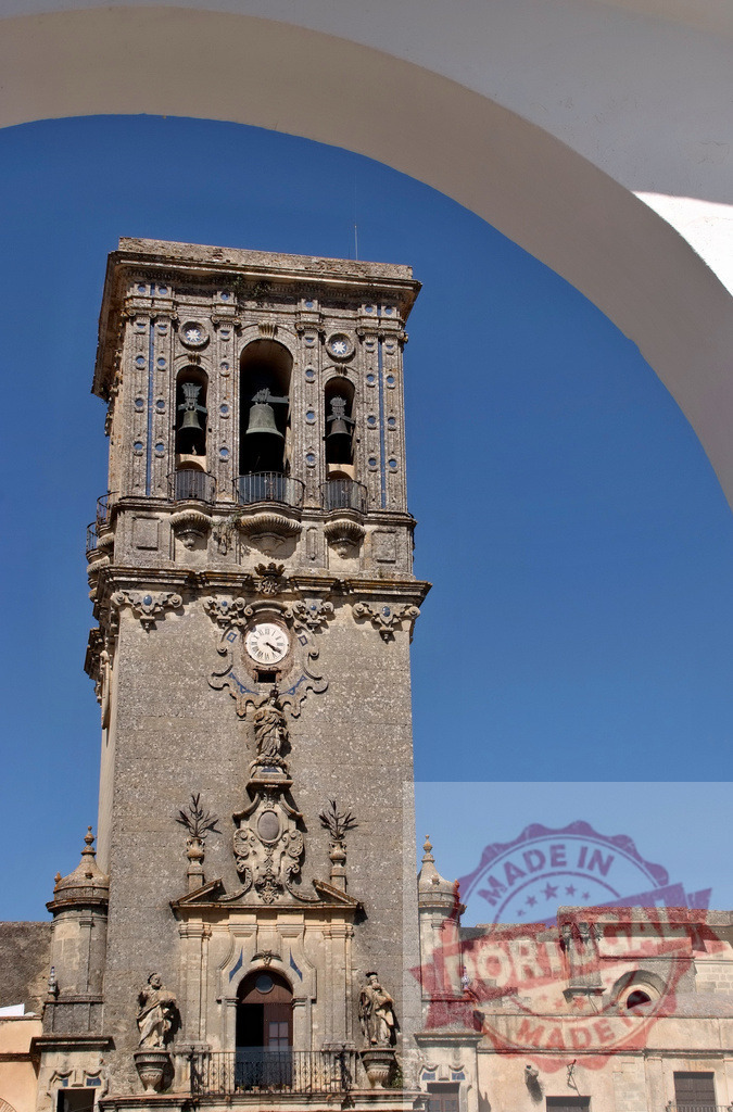 Collegiate Church tower clock in Arcos de la Frontera, Spain. Extremdura - Spain | Bell tower of Basilica de Santa María de la Asunción under a clear blue sky - Realized with Pictrs.com