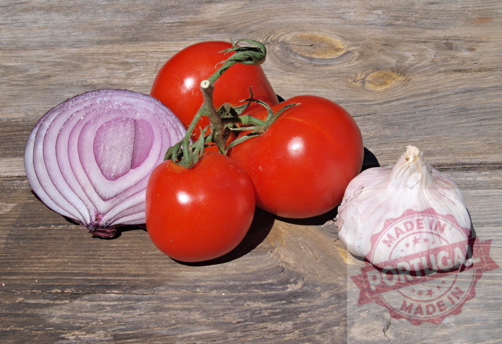 Fresh organic tomatoes red onion garlic rustic wood | Fresh tomatoes, red onion, and garlic display healthy eating on a rustic wooden background - Realized with Pictrs.com