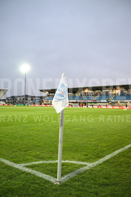 TSV Egger Glas Hartberg vs SV Oberbank Ried – Austrian Bundesliga Match | TSV Egger Glas Hartberg and SV Oberbank Ried. High-intensity match action, tackles, shots on goal, celebrations, fan atmosphere and stadium scenes captured in professional quality. The image shows the corner flag from Hartberg.