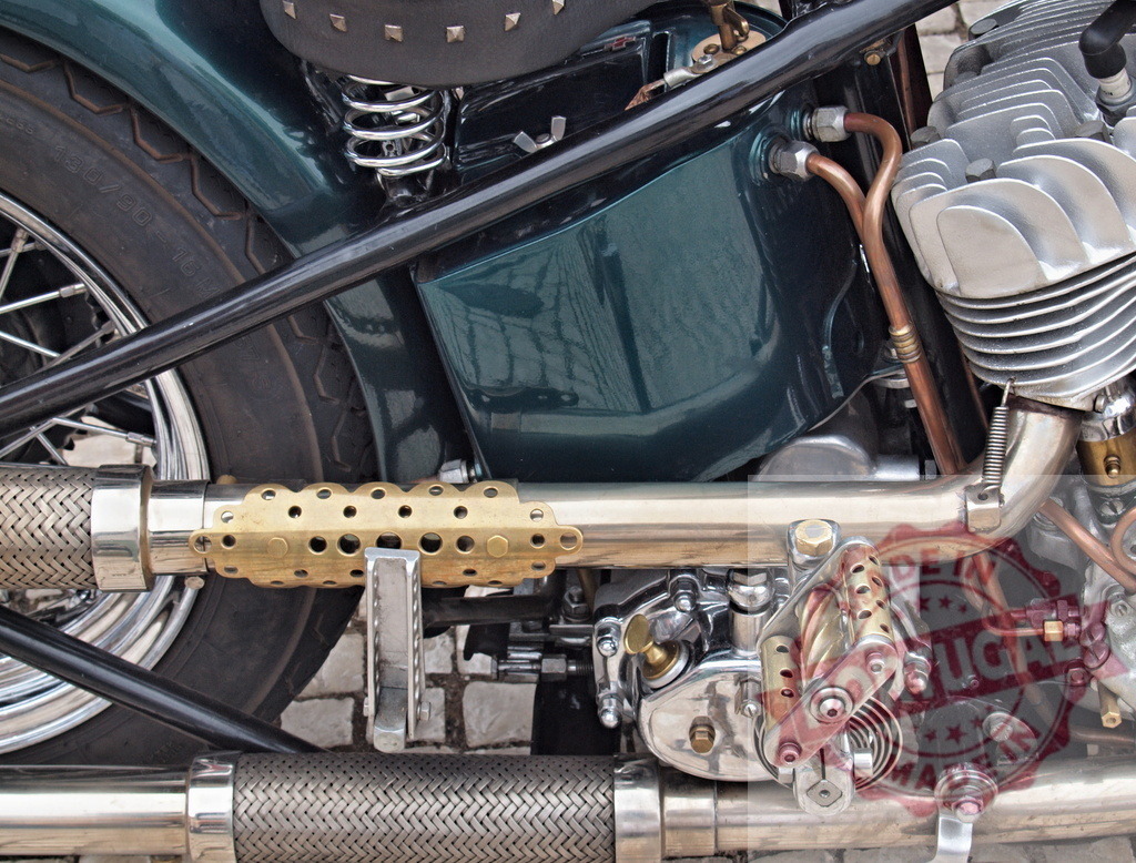 Custom vintage motorcycle engine detail showing exhaust pipe | Close-up of a classic motorcycle's engine, exhaust, and mechanical details - Realized with Pictrs.com