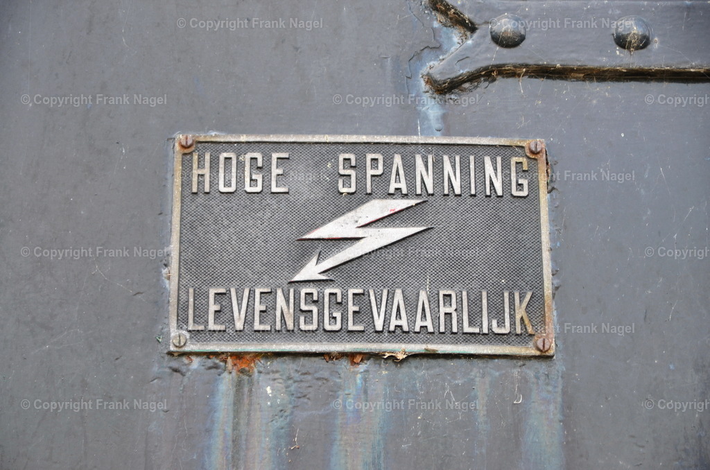 Niederländisches Warnschild Hochspannung | Das Foto ist ein niederländisches Warnschild für Hochspannung. Das Farbspiel auf der Fläche spiegelt die Spuren der Vergangenheit wieder. - Realisiert mit Pictrs.com