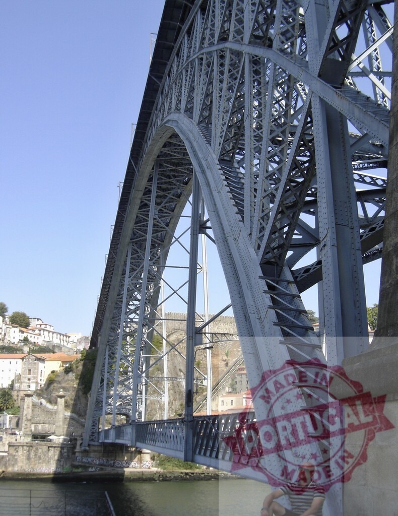 Dom Luís I Bridge arch over Douro River Porto. Porto - Portugal | Man sitting under the iconic steel arch of the Dom Luís I Bridge, Porto - Realized with Pictrs.com