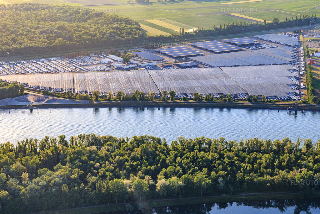 Vue aérienne: Zone industrielle et portuaire avec aire de stationnement pour véhicules ombragée par des systèmes photovoltaïques, exploitée par CEVA Logistics à Marckolsheim dans le département Bas Rhin, France – .Photo: IMG_147923.jpg prise le 30/05/2025 par Werner Riehm/FLY-FOTO.eu – Résolution de l'original: 5472 x 3648 px – WWW.CEVALOGISTICS.COM