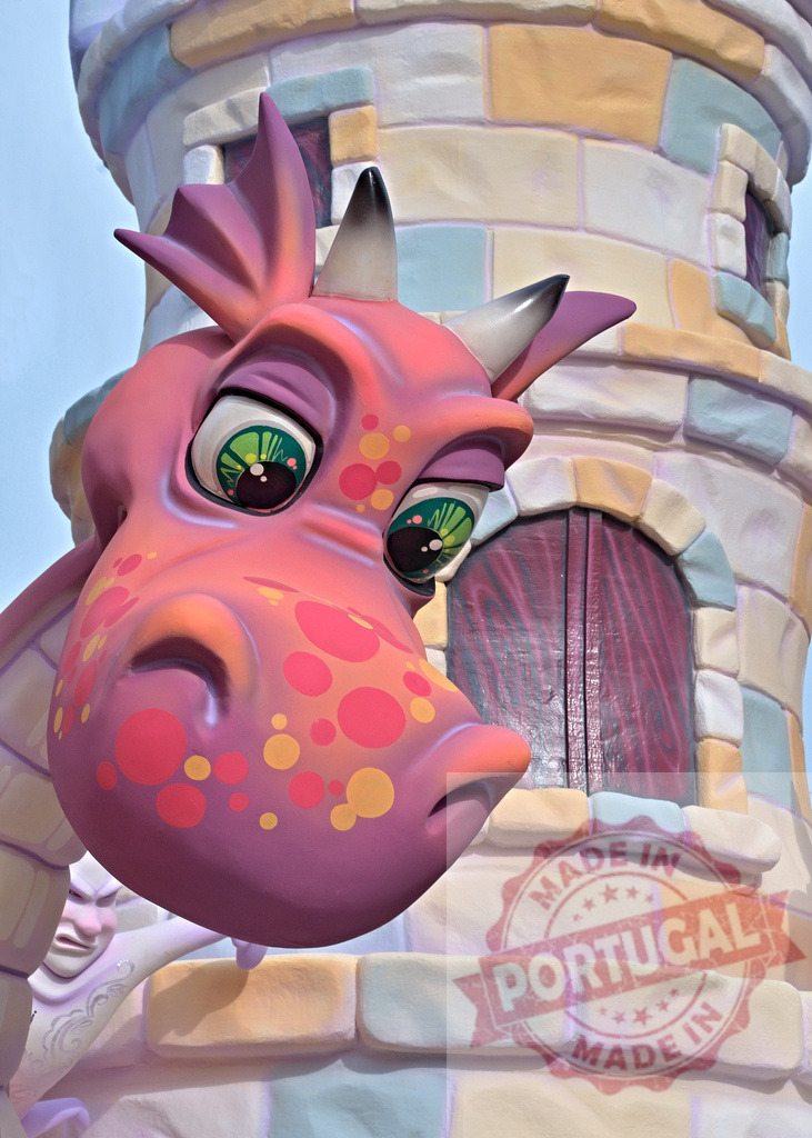 Pink fantasy dragon peering from castle tower. Fallas Fiestas Communidad Valenciana | Colorful cartoon dragon with green eyes peeking from whimsical fairytale castle - Realized with Pictrs.com