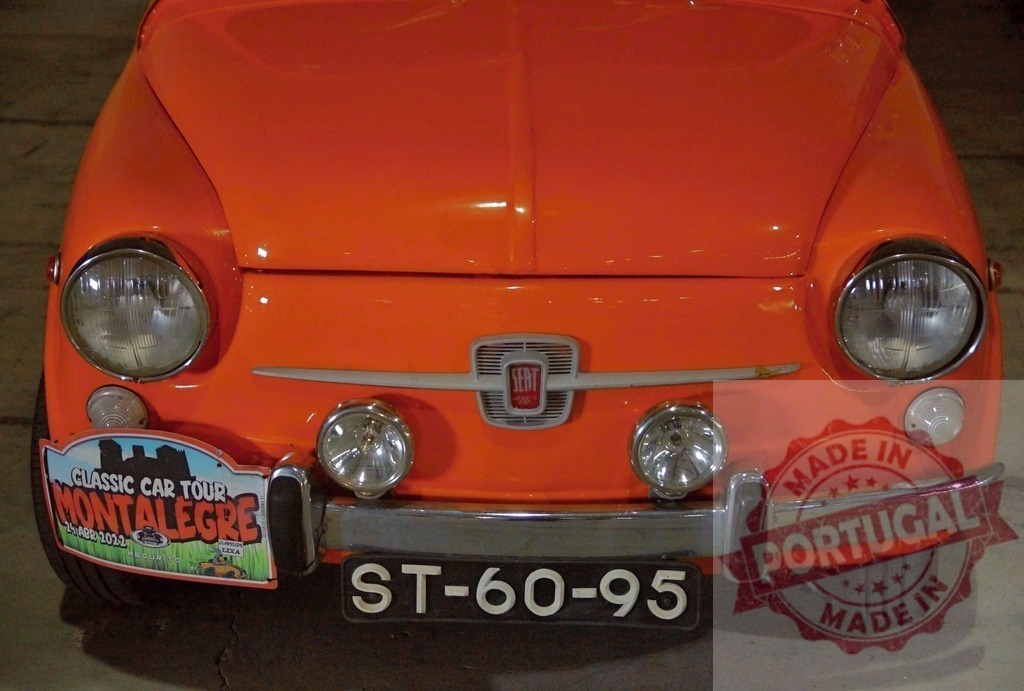 SEAT 600 orange classic car vintage automobile front | SEAT 600 classic car displaying its front details with headlights and bumper - Realized with Pictrs.com