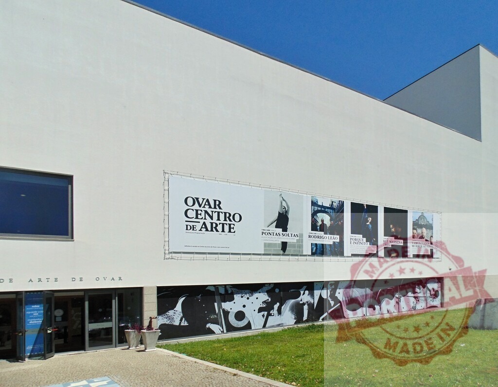 Ovar Centro de Arte building showing modern urban culture. Aveiro - Portugal | Ovar Centro de Arte building exterior featuring contemporary art exhibition banners promoting local culture - Realized with Pictrs.com