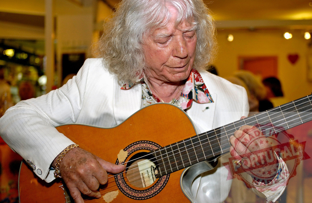 Senior musician playing spanish guitar during a concert | Elderly musician playing classical guitar during a live performance - Realized with Pictrs.com