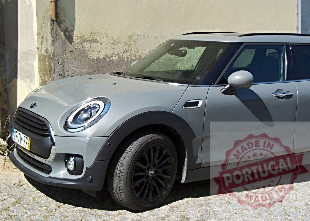 Modern Mini Clubman parked near weathered wall | Stylish Mini Clubman parked near a weathered wall, showcasing its sleek design and contemporary appeal - Realisiert mit Pictrs.com