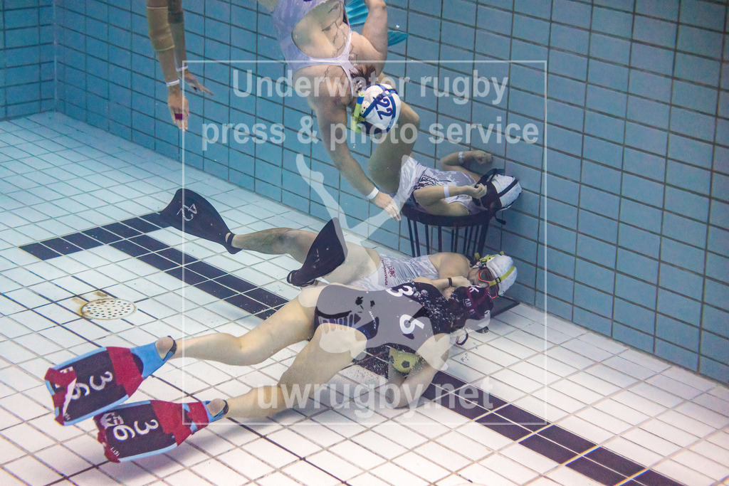 24. - 26.11.2023: Unterwasser-Rugby Champions Cup 2023  | Damen-Spiel: UWRC Wien (Österreich) in blau gegen Helvetia (Schweiz) in weiß. Die Österreicherin Elisabeth Marecek (blau #36) greift alleine das schweizer Tor an. - Realisiert mit Pictrs.com