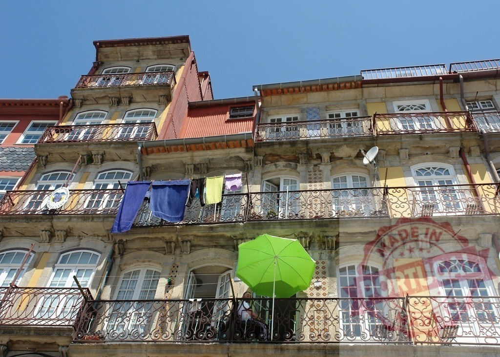Ribeira architecture with laundry drying on balconies. Porto - Portugal | Traditional facades and balconies in Porto with drying clothes under a clear blue sky - Realized with Pictrs.com