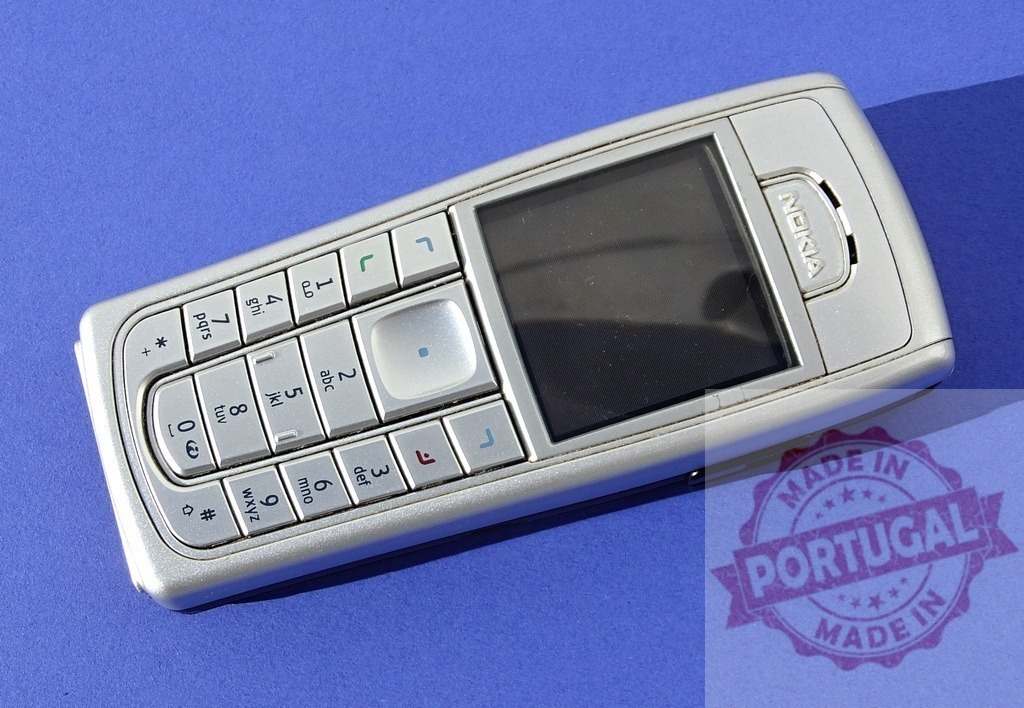 Nokia mobile phone lying on blue background | Old used Nokia cell phone on a blue background representing obsolete technology - Realisiert mit Pictrs.com