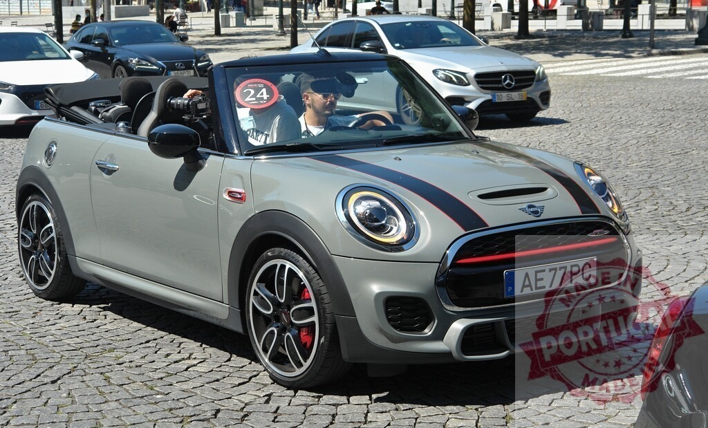 Man driving convertible Mini John Cooper Works in city traffic | Cameraman driving gray Mini John Cooper Works convertible during a test drive in city traffic - Realized with Pictrs.com