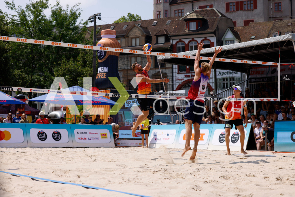 Obi BeachTour 2026 - Basel | BASEL, SWITZERLAND - JULY 19: MORITZ KINDL (AUT) attack / spike against MATHIS KÄLIN (SUI) block during the Obi BeachTour 2026 match between LEITNER / KINDL (AUT) and BREER / KÄLIN (SUI) at Barfüsserplatz on July 19, 2026 in Basel, Switzerland. - Realisiert mit Pictrs.com