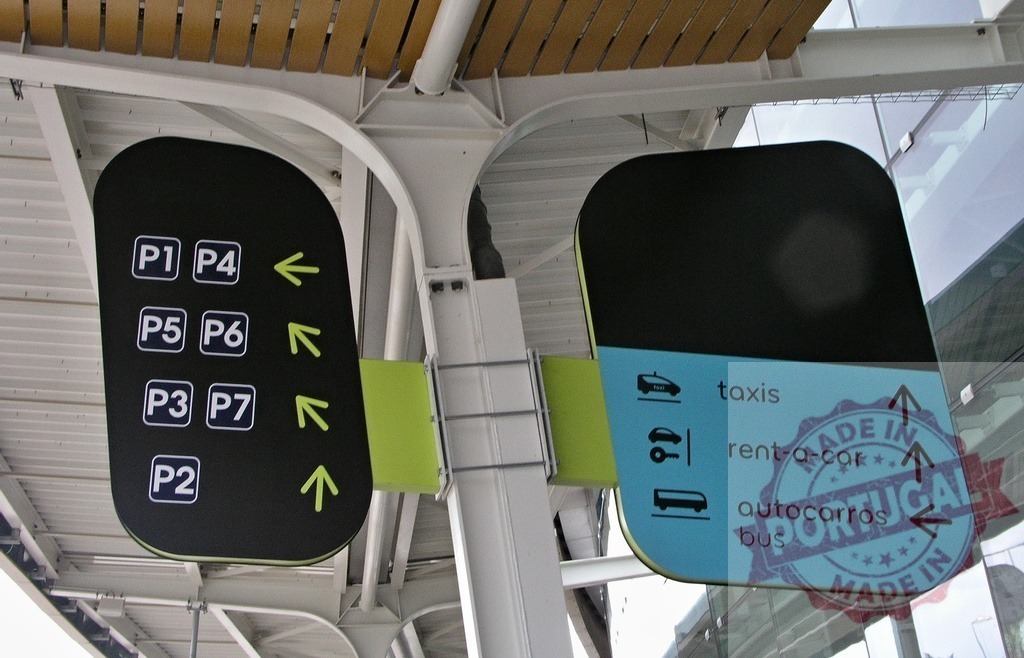 Airport parking and transport signs guiding passengers | Modern airport signs directing visitors to parking, taxis, buses, and rental cars - Realized with Pictrs.com