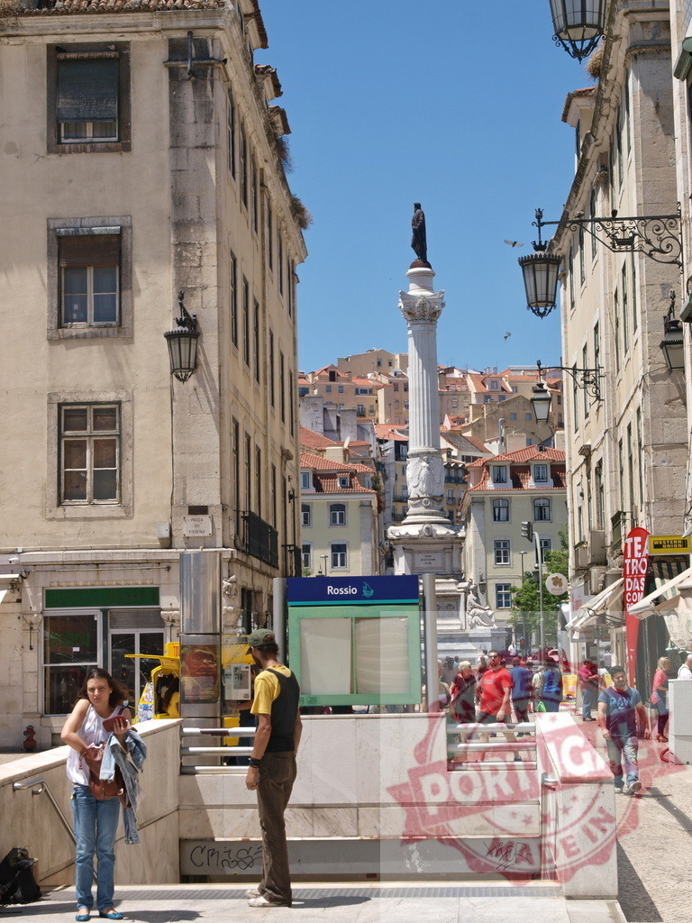 Rossio square, Lisbon, Portugal, with Pedro IV column | People by the Rossio metro entrance with the historic Pedro IV column in the background - Realized with Pictrs.com