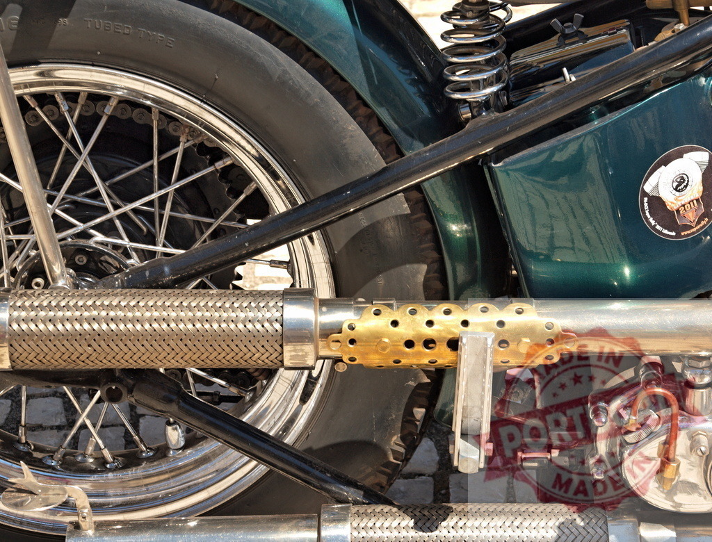 Custom vintage motorcycle exhaust system detail | Close up of a customized vintage motorcycle's shiny mechanical parts and exhaust - Realized with Pictrs.com