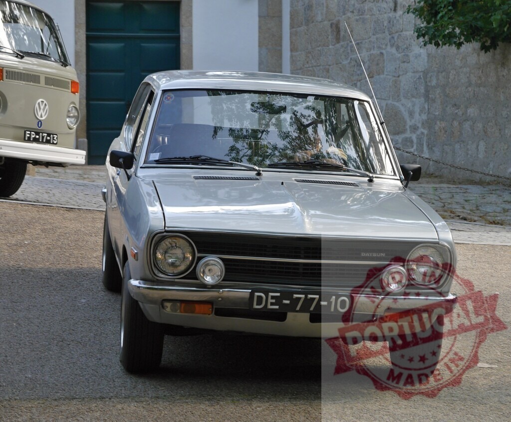 Datsun 120Y vintage car parked on street | Datsun vintage car parked on a European street with a Volkswagen van in the background - Realisiert mit Pictrs.com