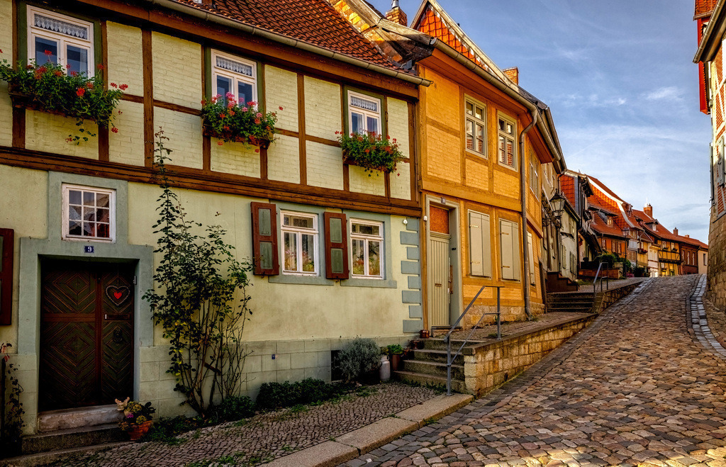 Mittelalterliches Ambiente der Gassen in Quedlinburg, Fachwerkhäuser | Das Bild zeigt die historische Altstadt von Quedlinburg in Sachsen-Anhalt. Quedlinburg ist bekannt für eines der am besten erhaltenen Fachwerkensembles in Deutschland mit über 2000 Häusern. Die Stadt wurde 1994 in die Liste des UNESCO-Weltkulturerbes aufgenommen. Die erste urkundliche Erwähnung stammt aus dem Jahr 922. Die Altstadt zeichnet sich durch verwinkelte Gassen und mittelalterliches Ambiente aus.  - Realisiert mit Pictrs.com