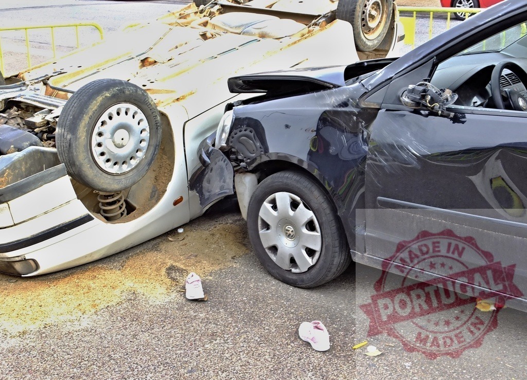 Car accident involving two vehicles and children's shoes lying on the asphalt | Two damaged cars after a collision, with children's shoes scattered on the ground, suggesting a possible family involvement - Realized with Pictrs.com