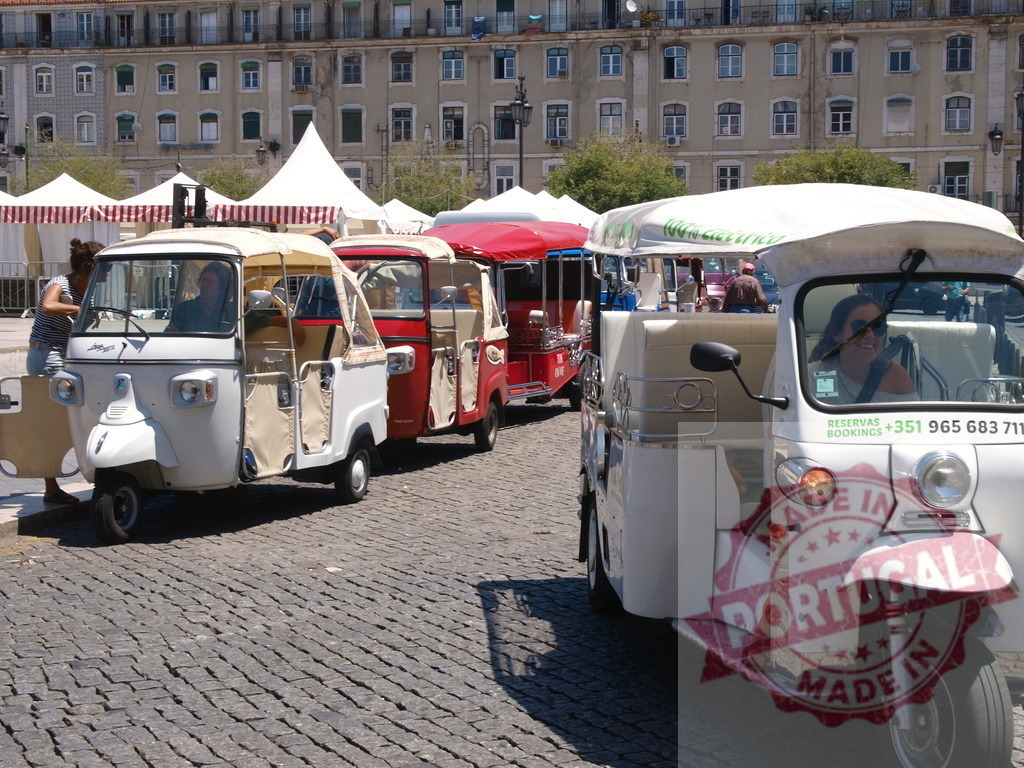 Tuk-tuks offering city tours in Lisbon, Portugal | Tuk-tuks parked on a cobblestone street, waiting for tourists to begin a city tour - Realized with Pictrs.com