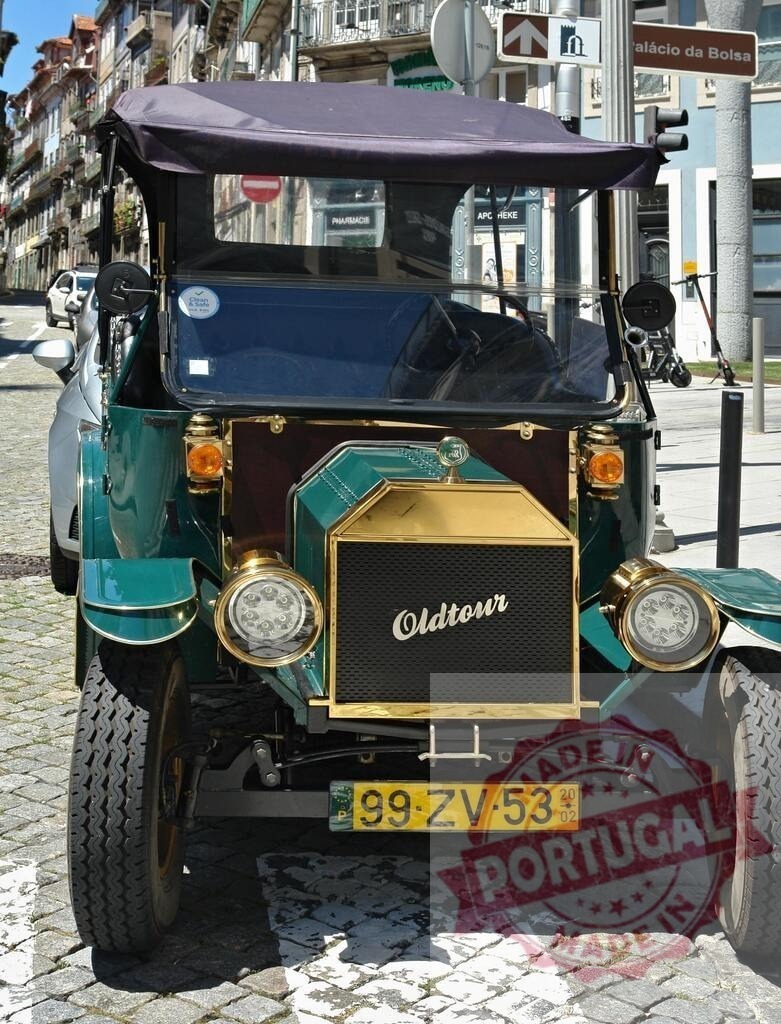 Green oldtimer parked in Porto near Palácio da Bolsa | Classic green car parked on cobblestone street in Porto, Portugal, with Palácio da Bolsa sign in background - Realized with Pictrs.com