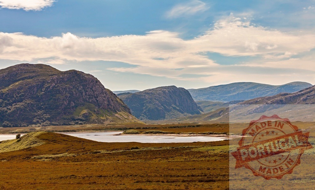 Scottish Highlands landscape showing loch and mountains | Expansive view of a natural loch surrounded by vast moorland and rugged mountains under a blue sky - Realized with Pictrs.com