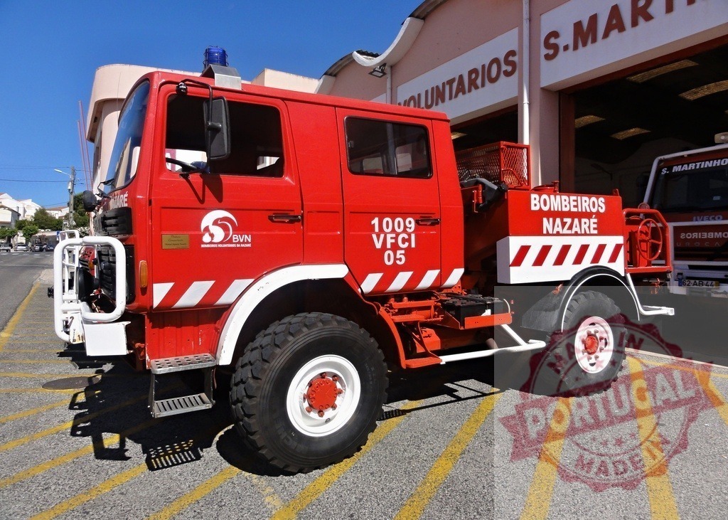 Bombeiros Nazaré fire engine parked at fire station | Red fire engine from Bombeiros Voluntários de Nazaré parked outside a fire station in Portugal - Realized with Pictrs.com