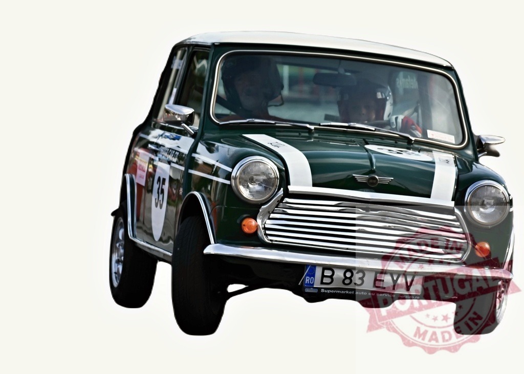 Classic Mini Cooper speeding during a vintage car rally competition | Vintage Mini Cooper racing on a track during a rally competition for classic cars - Realized with Pictrs.com