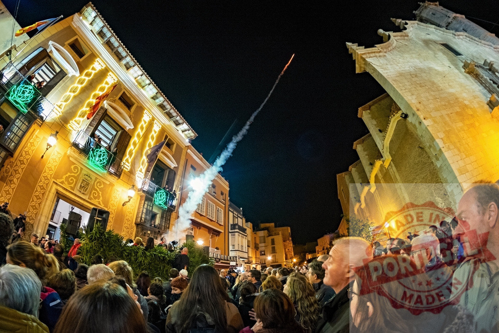 Watching fireworks launching during a nighttime festival in Valencia Spain | Crowd of people looking up at a firecracker launching from a building during a city festival - Realized with Pictrs.com