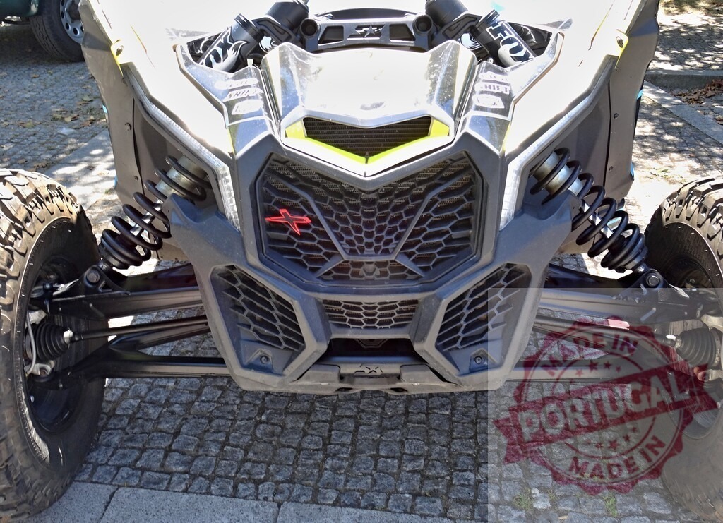 Can-Am Maverick X3 all-terrain vehicle showing front suspension and radiator | Close-up of the front of a Can-Am Maverick X3, highlighting its robust suspension and radiator design - Realized with Pictrs.com