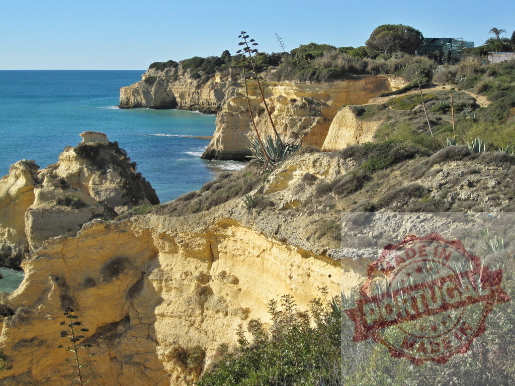 Algarve Portugal coast with Atlantic ocean and limestone cliffs. Algarve - Silves | Portugal's Algarve coast with rugged limestone cliffs and the Atlantic Ocean under a clear sky - Realized with Pictrs.com