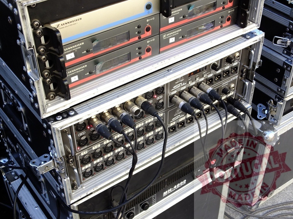 Sennheiser equipment and cables connecting audio devices in flight cases | Professional audio equipment setup with Sennheiser wireless receivers, cables, and flight cases, ready for a live event or concert - Realized with Pictrs.com