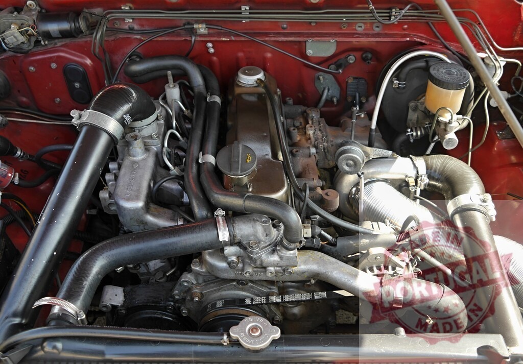 Working turbo car engine bay detail | Diesel car engine bay with turbocharger, belts, and hoses - Realisiert mit Pictrs.com