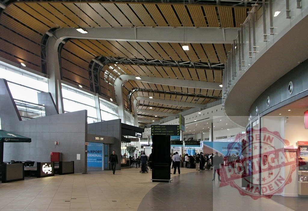 Faro Airport new terminal interior with travelers and modern design | Faro Airport terminal interior displaying modern architecture and travelers - Realized with Pictrs.com