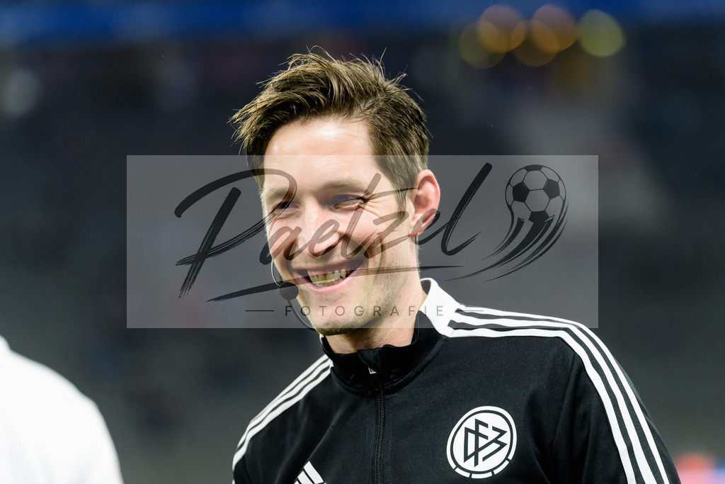 BSCRBL20220220_265 | Fussball, Herren: Vierter Offizieller Dr. Matthias Joellenbeck lacht, lachen bei dem Spiel der 1. Bundesliga zwischen Hertha BSC und RB Leipzig im Olypiastadion am 20.02.2022 in Berlin, Deutschland.DFB / DFL REGULATIONS PROHIBIT ANY USE OF PHOTOGRAPHS AS IMAGE SEQUENCES AND/OR QUASI-VIDEO. - Realisiert mit Pictrs.com