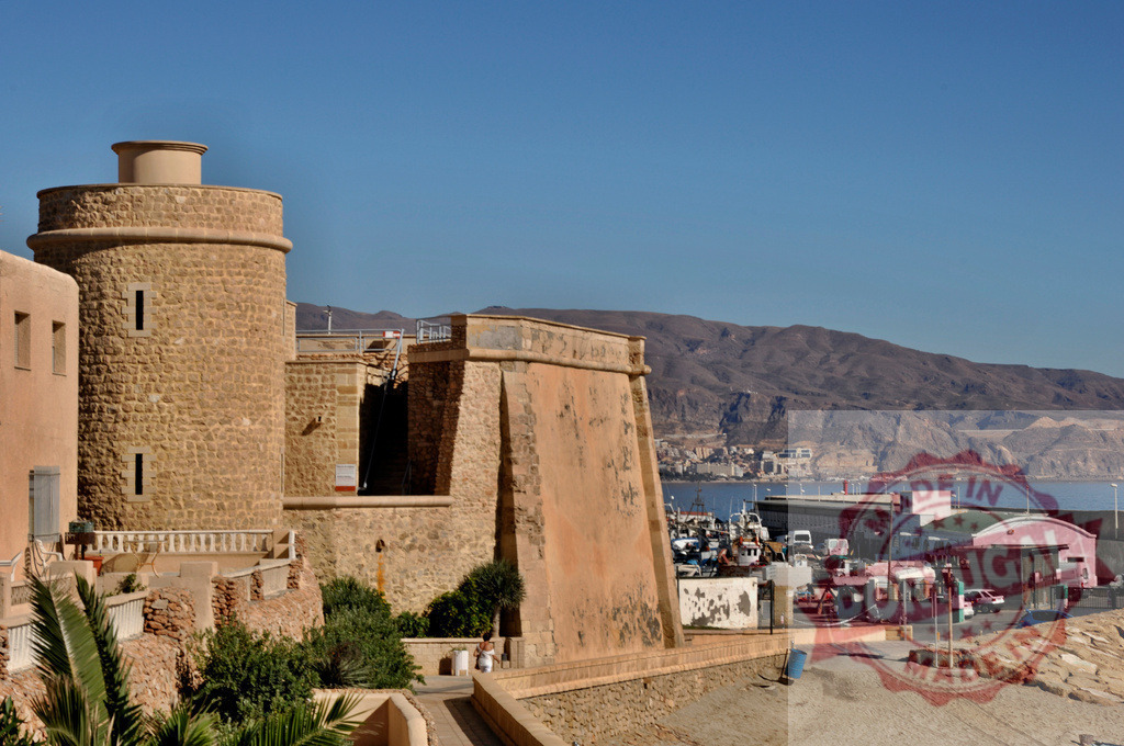 Alcazaba fortress in Almería with harbor and mountains | Historic Alcazaba fortress overlooking Almería port, reflecting history and travel in Andalusia, Spain - Realisiert mit Pictrs.com