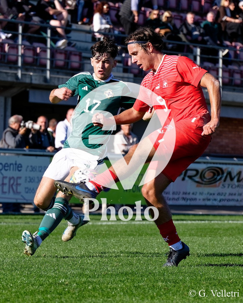 UEFA Region's Cup - NI Western Region v Vaud | Julien Beausire (9 Vaud) and John Butcher (17 NI Western Region) battle for the ball (duel) during the UEFA Region's Cup game between NI Western Region and Vaud at Centre Sportif de Colovray in Nyon, Switzerland 