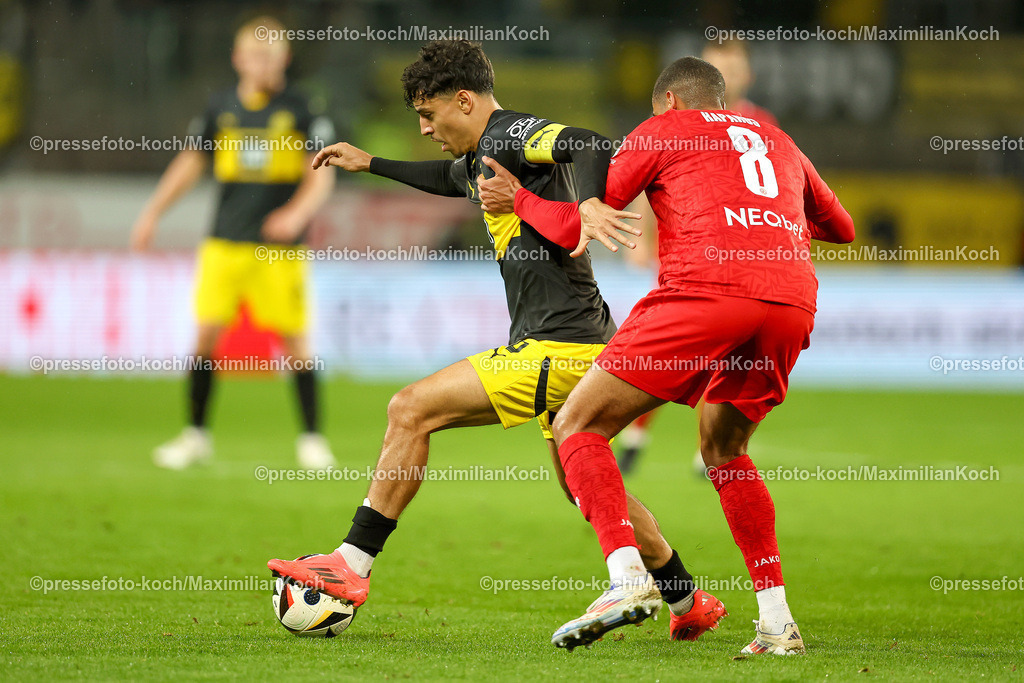 RWE3Liga25092401035 | 25.09.2024, Essen, Fußball,  Rot-Weiss Essen – Borussia Dortmund II (U23), bwin 3. Liga Herren, Stadion an der Hafenstraße, 7. Spieltag Saison 2024 2025: Ayman Azhil (BVB II #6) gegen Jimmy Kaparos (RWE #8) DFB regulations prohibit any use of photographs as image sequences and or quasi-video.