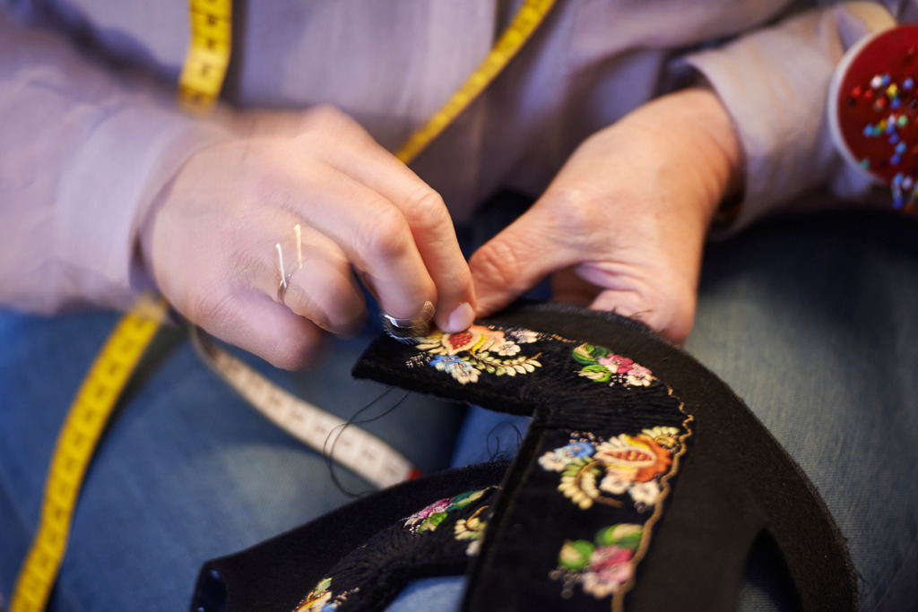 Juppo und Emlmachare | Bezau, Austria - March 09, 2016: Juppo und Emlmachare.; Frau Maria Meusburger beim besticken. - Realisiert mit Pictrs.com