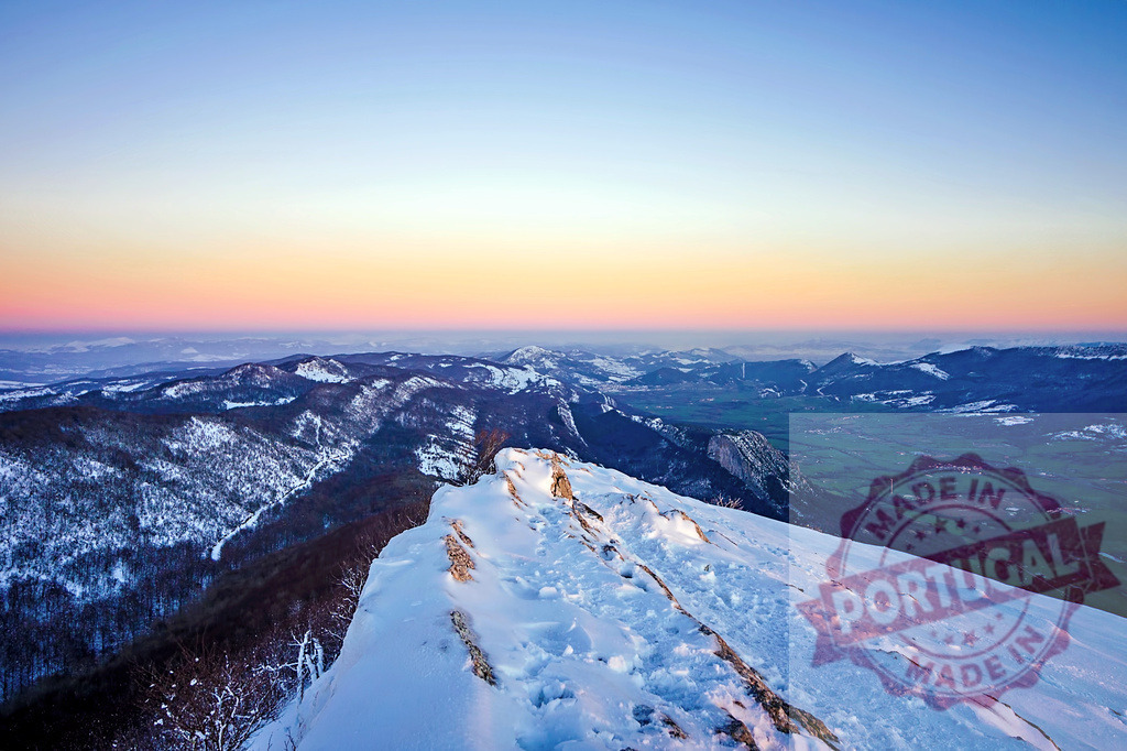 Snowy mountain peak during colorful sunset over winter valley | Breathtaking view of a snowy mountain peak during a colorful sunset over a winter valley - Realized with Pictrs.com