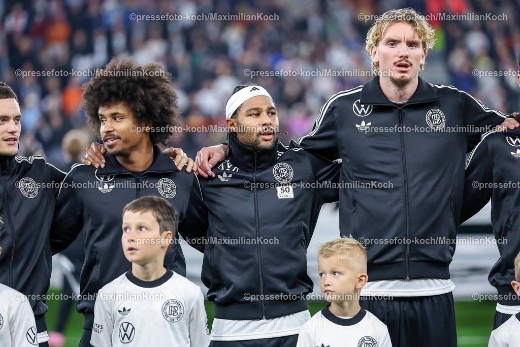 DFB10102502133 | 10.10.2025, Fußball, Länderspiel, Deutschland - Luxemburg, UEFA WM-Qualifikation, 2025/2026, Gruppe A, PreZero Arena in Sinsheim: Karim Adeyemi (GER #14) neben Serge Gnabry (GER #20)  und Nick Woltemade (GER #11) bei der NationalhymneDFB regulations prohibit any use of photographs as image sequences and or quasi-video.