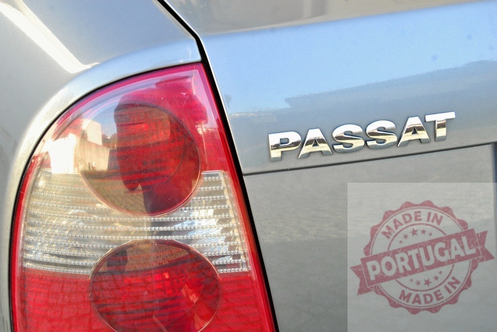Volkswagen Passat car taillight and chrome emblem | Silver Volkswagen Passat car with red taillight and chrome brand name - Realized with Pictrs.com