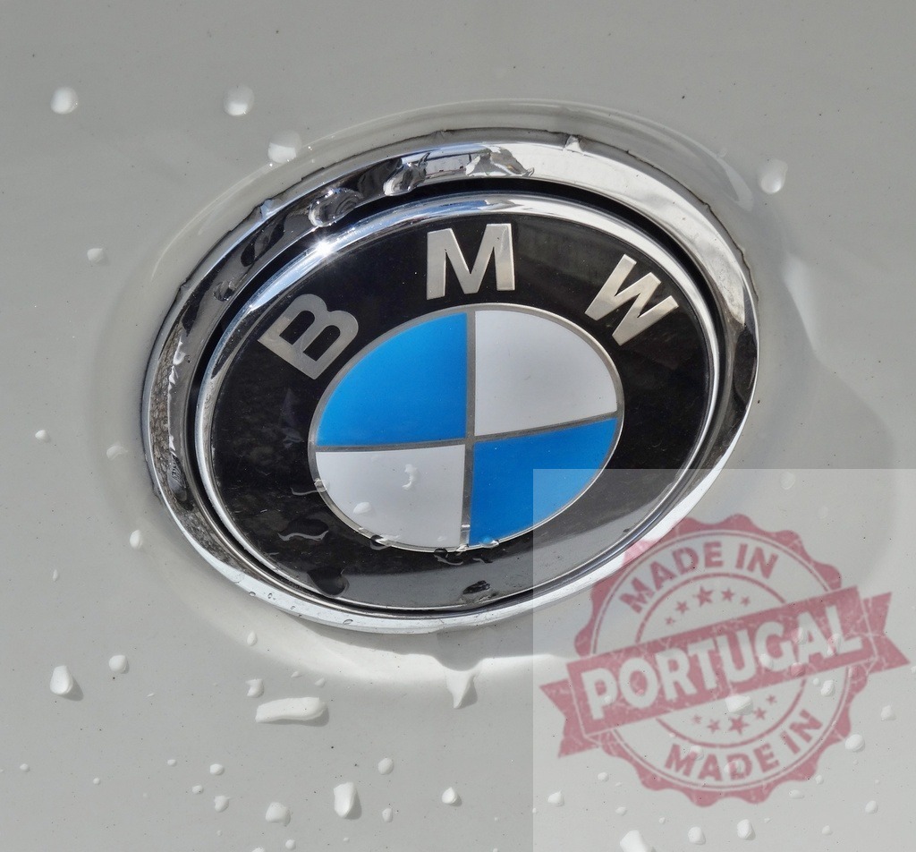 BMW logo on car with water drops | BMW logo emblem on a luxury vehicle surface with water droplets from washing - Realized with Pictrs.com