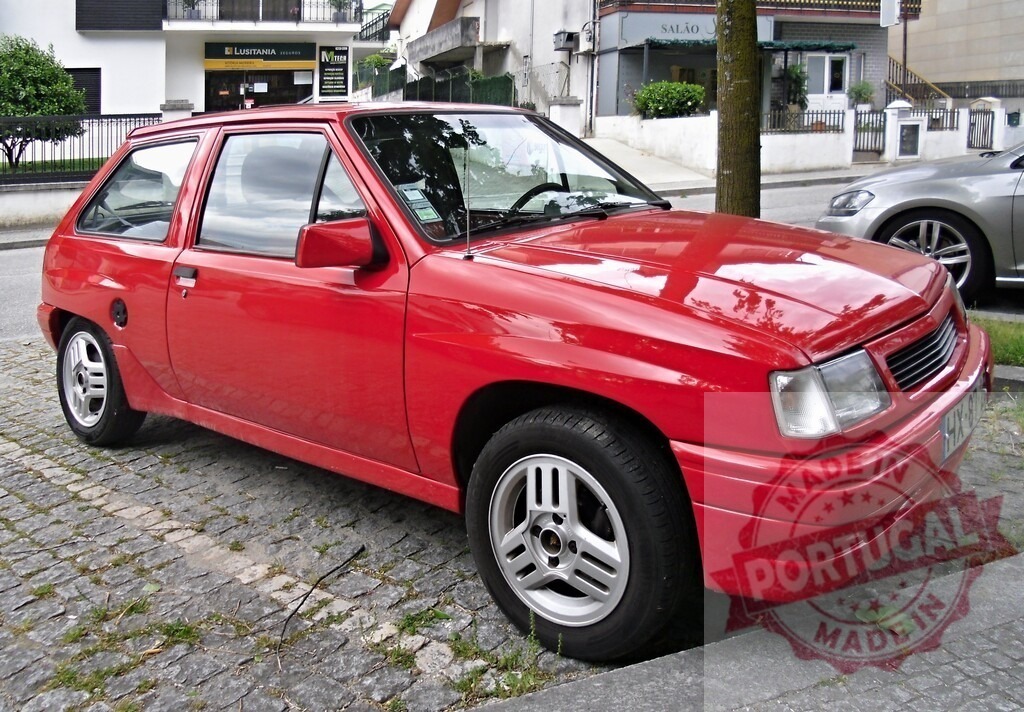 Red Opel Corsa A hatchback parked on cobblestone street | Vintage red Opel Corsa A hatchback parking on a historical cobblestone town street - Realisiert mit Pictrs.com