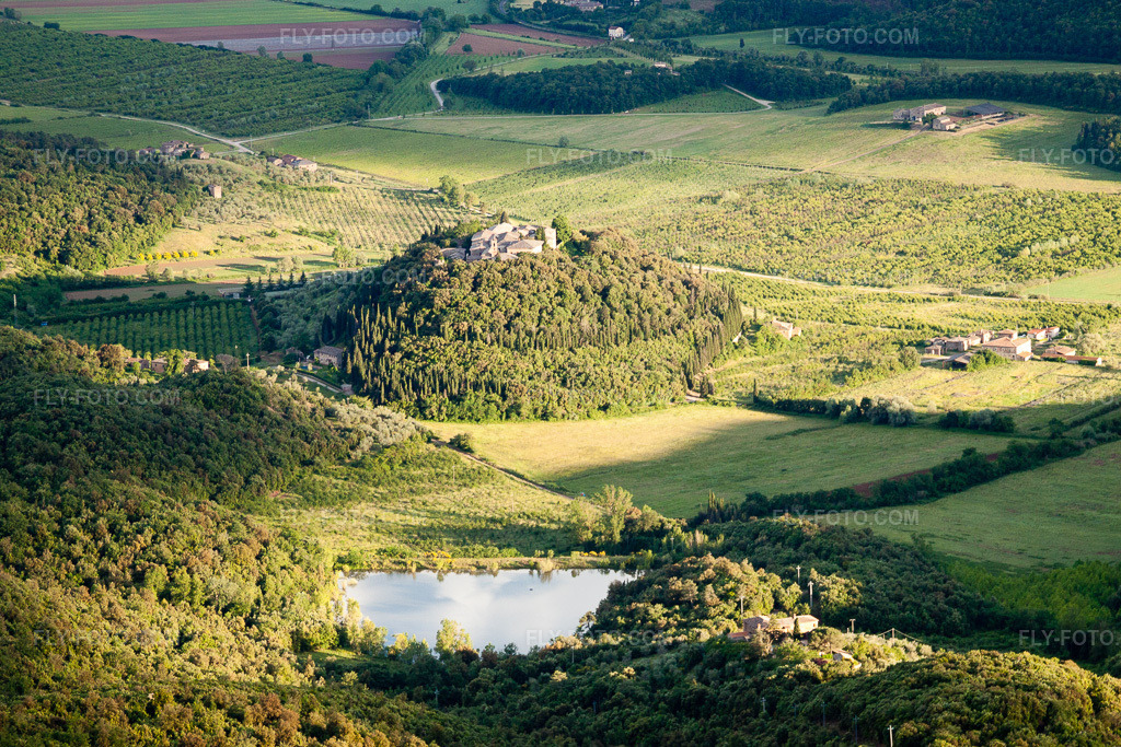 Aerial view: Village view on a wooded, rounded hill with a lake in the district Poggio Santa Cecilia in Rapolano in the state Siena, Italy.Photo: IMG_28546.jpg taken on 06/03/2010 by Werner Riehm/FLY-FOTO.comResolution of the original: 3904 x 2603 px