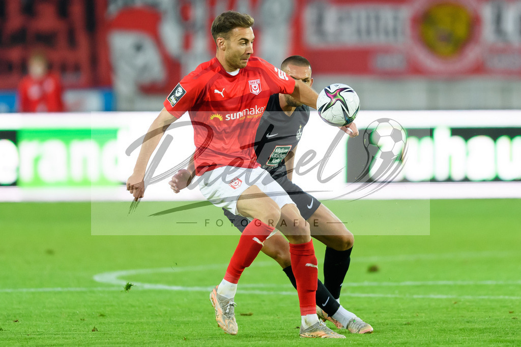 HFCFCK20210824_056 | Fussball, Herren: Michael Eberwein (Hallescher FC) und Rene Klingenburg (1. FC Kaiserslautern) im Zweikampf beim Spiel der 3. Liga zwischen Hallescher FC und 1. FC Kaiserslautern im Leuna-Chemie-Stadion am 24.08.2021 in Halle (Saale), Deutschland. - Realisiert mit Pictrs.com