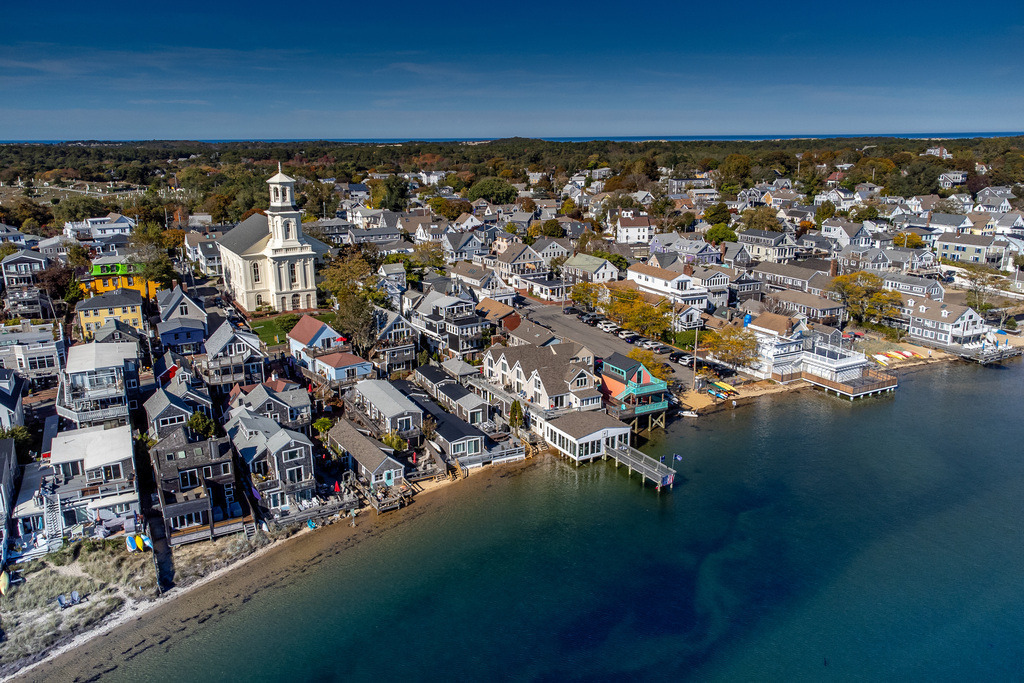 Cape Harmony | From above, Provincetown reveals its charming blend of seaside houses, winding streets, and the graceful tower of the Unitarian Church. A coastal symphony of color, light, and architecture captured on the tip of Cape Cod.