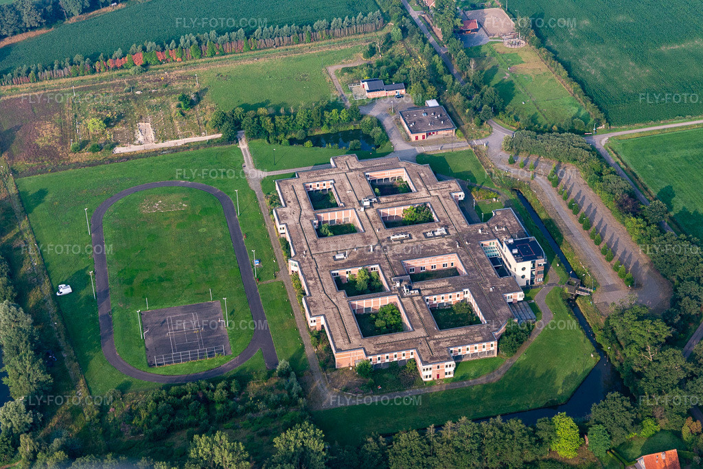 Aerial view: Prison grounds and security fence of the correctional facility. in Rekken in the state Gelderland, Netherlands. – Photo: IMG_008212.jpg taken on 07/18/2020 by Werner Riehm/FLY-FOTO.com – Resolution of the original: 4987 x 3325 px
